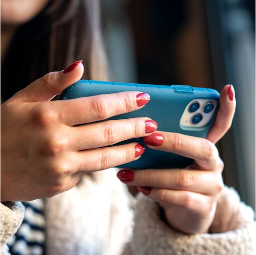 Woman holding phone with Moab case