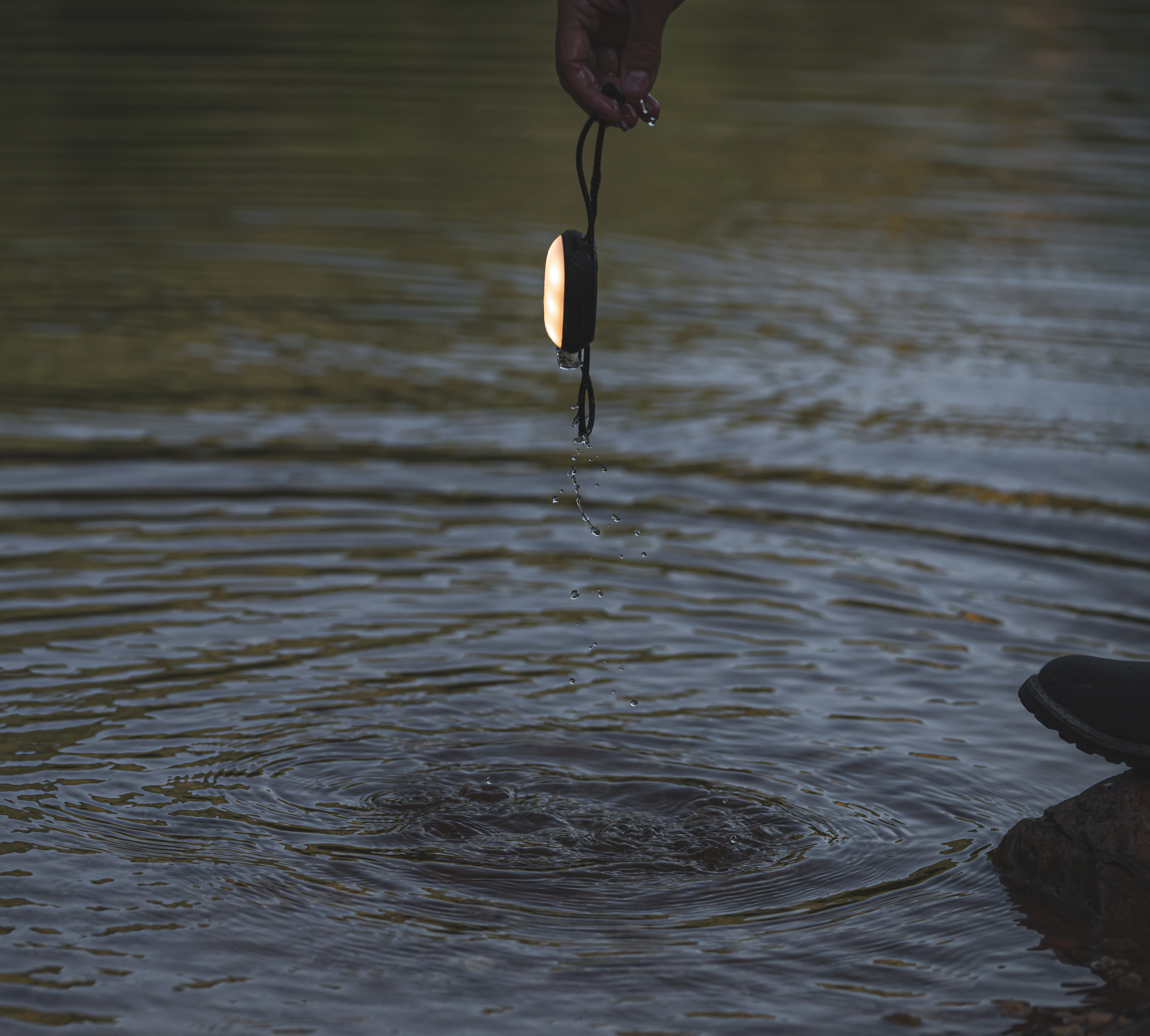 Cairn® Mini lantern being pulled out of water