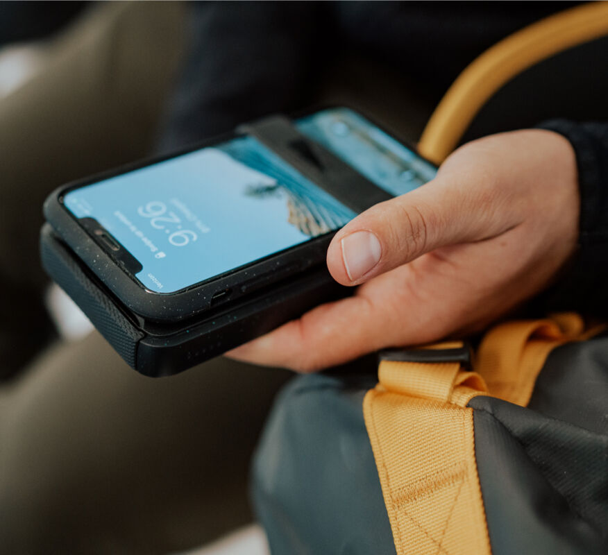 Wireless travel charger with phone securing band